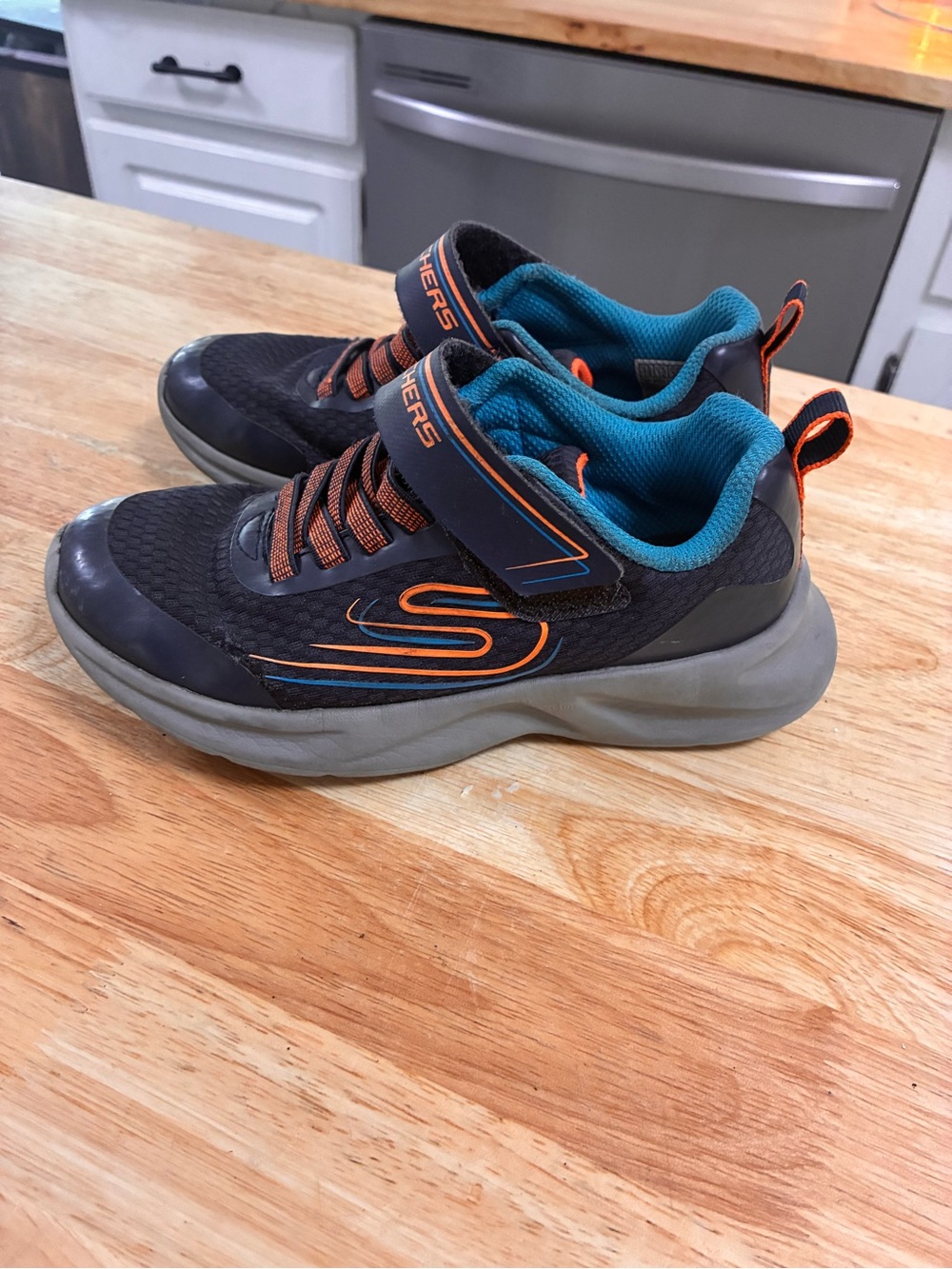 Skechers Kids Black Sneakers with Teal Lining and Orange Trim